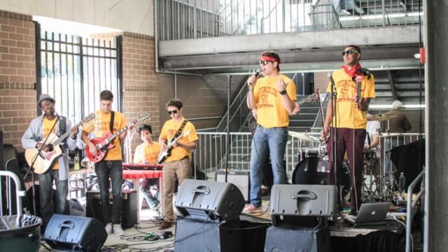 Members of Juice, the 2014 Battle of the Bands winner, perform at the SuperFan Zone concert before Saturday's game against Maine. 