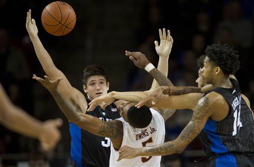 Duke guard Grayson Allen, left, grabs the rebound beyond the reach of Boston College forward Garland Owens Jr., center, during the second half of an NCAA college basketball game Saturday, Jan. 2, 2016, in Boston. Duke beat Boston College 81-64. (AP Photo/Gretchen Ertl)