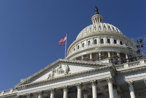 FILE - In this Tuesday, Sept. 6, 2016, file photo, an American flag flies over Capitol Hill in Washington, as lawmakers return from a 7-week break. The federal government recorded a deficit of $107.1 billion in August, slightly lower than the July deficit. But the imbalance through 11 months of this budget year is up sharply from a year ago, reflecting higher spending and lower-than-expected tax revenues. (AP Photo/Susan Walsh, File)