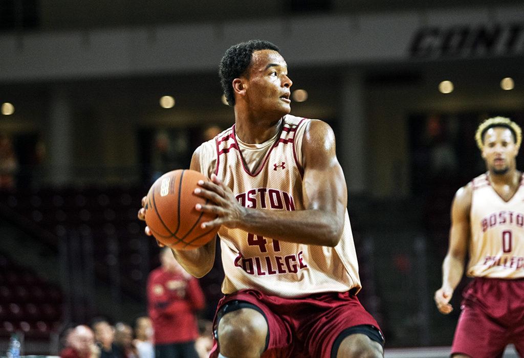 Power Gym is loud. The practice home of Boston College men’s basketball is filled with noise from the moment you step in through the doors. If the Eagles are going to be good, it probably needs to be. The ACC will punish teams mercilessly if they can’t communicate. Perhaps such an atmosphere would intimidate a newcomer. But Steffon Mitchell doesn’t look intimidated. Stationed on the block as the team works on its zone defense, the 6-foot-8 forward looks like he was born to play in head coach Jim Christian’s system. His large frame doesn’t inhibit him from keeping up with smaller players, and at 222 pounds, Mitchell is well-equipped to battle in the post. He doesn’t struggle to communicate with other defenders, never takes a possession off, and exudes professionalism that is hard to find in a player so young, specifically on the defensive end of the floor. Mitchell says it’s the hardest lesson he’s had to learn on the basketball court. “Back in the day, in AAU I played on the Minnesota Fury,” he said. “We would score a lot, shootout games, defense wasn’t that big of a priority. But, I think that as it kept going on later in the AAU season we focused more on defense, and that got us to win more games.” His focus shows at practice. One moment he’ll be in the paint bodied up against a bigger player, the next he’ll be switched out onto point guards behind the 3-point line. He never looks overwhelmed, and when Christian stops play to point out an error, Mitchell absorbs the information, asks a question or two, and then gets back to work. His high school coach Bruce Kugath, hailing from Shakopee, Minn., wouldn’t be surprised. “I’m pretty involved in our youth program, so I’ve seen Steffon as a player from third grade on up, and the thing that impressed me even when he was very young was that he was very competitive and just a basketball junkie,” Kugath said. “He just played and played and shot and shot and he never really changed.” Perhaps Mitchell’s work ethic stems from his early indoctrination to life in basketball. His father, Juan, coached Shakopee’s girls’ basketball team, and Steffon has played under his guidance since second grade. It was the perfect incubator for building a basketball player who can do it all. “I think he just had a burning desire to be a good Division I college basketball player ever since he was a little kid,” Kugath said. “Basketball, I think, was always his passion, and I don’t think that’s changed.” That attitude brought Mitchell immense success at the high school level. In addition to his defensive efforts, he graduated from Shakopee as the school’s all-time scoring and rebounds leader—Mitchell racked up 1,985 points and 800 rebounds during his four-year career. Kugath believes Mitchell had close to 500 assists as well. It’s hard to imagine Mitchell, probably closer to 6-foot-5 at the time, serving as his team’s primary ball handler, but his court vision justifies the temporary position change. By the time Mitchell graduated high school, he had already learned how to be the most versatile player on the court, filling any role a coach or situation would demand from him. During one practice this preseason, Mitchell came down with a rebound, and sensing opportunity, passed up on outletting the ball and instead dribbled easily up court to run the fastbreak. It only took him moments to find a streaking Vin Baker, Jr. with a nifty pass, leaving Baker an easy dunk. Moments like that have shined a light on Mitchell’s potential, and Christian has taken notice. The head coach has indicated Mitchell will play the three and the four, relying on his excellent rebounding ability and high basketball IQ to make a difference on the court. “Right now, he [is] one of our catalysts even though he’s a freshman,” Christian said. “He sets a tone out there for us—he’s very, very important.” * * * It’s taken a lot of work for Mitchell to get this point. After Shakopee, he decided to go to prep school for a year to hone his game. Despite his tremendous success at the high school level, he, and Kugath, knew he had room for improvement. Kugath and Mitchell had a conversation during his sophomore year, in which Mitchell voiced his concerns about his usage as a center rather than as a perimeter player. His goal has always been to be a D-I college basketball player, and although Mitchell is big, he already knew that in college he would be best suited to play on the perimeter. Kugath asked him to sacrifice. In order for Shakopee to get wins, they needed Mitchell, their biggest player down low. The results spoke for themselves, as Shakopee finished third in their league twice behind Mitchell, who shattered school records in the process. Mitchell would work on his perimeter game outside of the regular game plan, and whenever a situation would call for it he would step behind the 3-point line to run the offense. He wouldn’t have to sacrifice for long though. Mitchell went to Sunrise Christian Academy in Kansas for his prep year. While there, he’d work under head coach Kyle Bankhead, who was immediately impressed. “What stood out about him, I think he’s an every-day guy, and what I mean by that is he brings his lunchpail every day to work,” Bankhead said. “He has the same attitude every day, and he doesn’t let outside influences change who is is.” While at Sunrise Christian Academy, Mitchell worked more on the outside shot he had previously sacrificed. According to Bankhead, Mitchell’s natural position in college is as a face-up stretch four. Mitchell can pass and shoot, and has moved away from some of the less natural post-game he grew up playing. Both Kugath and Bankhead felt that before Mitchell could excel at the collegiate level, his footwork and body type needed to be worked on. Mitchell is a good athlete, especially laterally, but after so many reps in the post at Shakopee, Sunrise was the perfect place to refine his athleticism. In prep school, Mitchell was freed to operate primarily on the perimeter, only venturing to his old spots in the post to take advantage of mismatches. Now, as he begins at the collegiate level, Mitchell has had extensive exposure to low post and perimeter play on both ends of the court. His presence gives the Eagles a unique asset to take advantage of various inefficiencies in opposing game plans. Mitchell’s broad skillset gives BC more options when the team is trying to take advantage of any weakness an opposing team will have. If the Eagles play their cards right, Mitchell could play a huge part in adding to the team’s win total. Bankhead is quick to mention that Mitchell’s improved shooting ability is a big key to his success at the college level. He believes that if Mitchell can reach his 3-point shooting potential—making 40 percent of those shots or so—he’ll be extremely difficult to guard, regardless of the athletic improvements he’s worked on the last few years. Mitchell’s outlook also translates to his big game performances. Kugath mentioned that although Mitchell is extremely unselfish on the floor, to the point where sometimes against lesser opponents he isn’t aggressive enough, against better teams Mitchell’s game escalates to new levels. Mitchell functioned more as a ball-handler alongside his primary scoring capabilities and never shied away from the big stage. Bankhead adds that a lot of Mitchell’s time at Sunrise was geared toward learning to be more aggressive in big moments, but also further integrating Mitchell’s flexibility into important gameplans to create advantages opposing teams couldn’t deal with. His defensive capabilities alongside his inside-outside game and high basketball IQ make him difficult to keep up with, and his selfless playing style endears Mitchell to his teammates. Baker, Jr. has experienced that selflessness firsthand. He believes Mitchell’s rebounding ability opens up incredible opportunities for his teammates. “We have a lot of good shooters,” Baker, Jr. said. “When he rebounds like he does offensively, it just opens up for more opportunities, more second-chance points.” Kugath couldn’t be more proud to have coached Mitchell, the ultimate team player with a passion for winning and an attitude that makes him a Swiss army knife on the court. Mitchell has turned into a weapon that BC cannot only use, but could push the team to another level. Bankhead, who has stood witness to much of Mitchell’s progress into a player with immense potential, thinks the college basketball world is about to be taken by surprise. “I just think it’s important everybody knows how wonderful a kid he is,” Bankhead said. “He’s a special, special kid. I don’t think BC even knew how good of a kid they were getting. If you were behind closed doors, they’d be scratching their heads like ‘Dang, I didn’t know he was going to be this good.’” Christian didn’t either. “I think he’s the guy that nobody knew about, and in some regards even I didn’t know, how good he was,” Christian said. “He’s really good … I think if you asked the guys on our team ‘Which guy on our team takes the most pride on doing the little things to win,’ I think it would be unanimous: Steff Mitchell.” *** Back on the practice floor, Mitchell is guarding on the perimeter. He and his teammates don’t get the coverage right on a play the scout team is running, and give up a tough basket. The ball bounces to Mitchell, who gathers it, and in a brief moment of frustration gives it one hard dribble before lobbing it back out to run the play again. This time, the play comes to an end when Mitchell and his teammates lock the coverage up perfectly, and Mitchell closes out quickly on a 3-point attempt to make a difficult block. He comes up with the ball and a smile, quickly handing it back to the scout team to run the next play. He daps up his teammates, then gets back into his stance. Power Gym is loud, but Steffon Mitchell is ready to bring the noise to Conte Forum.