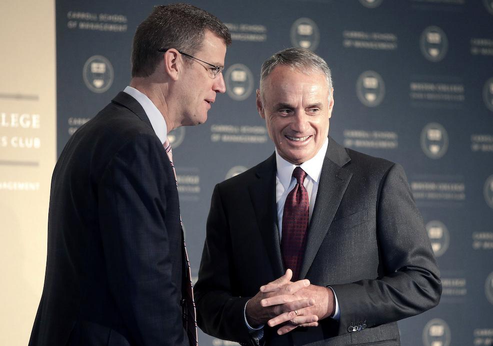 Boston Red Sox President and CEO Sam Kennedy, left, and Major League Baseball Commissioner Rob Manfred, right, speak before addressing an audience at a gathering of the Boston College Chief Executives Club, Wednesday, March 6, 2019, in Boston. (AP Photo/Steven Senne)