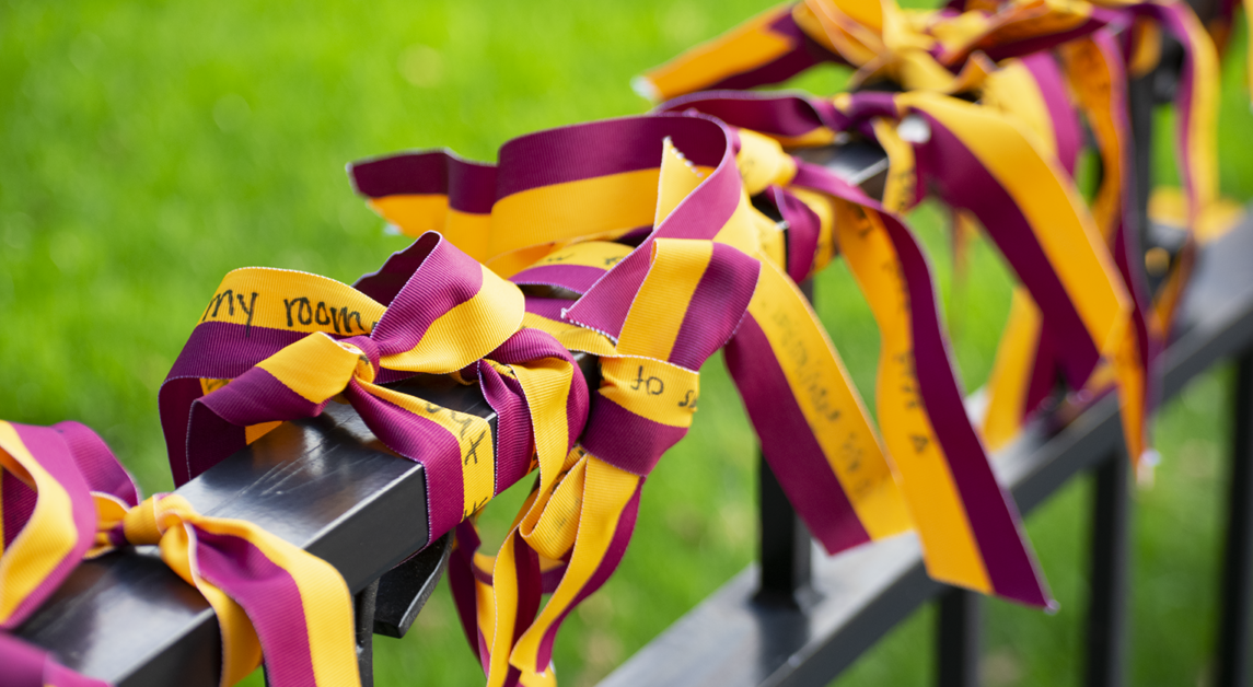 The Boston College community tied hundreds of maroon and gold ribbons with their prayers written on them to the fences surrounding Bapst Library last week.