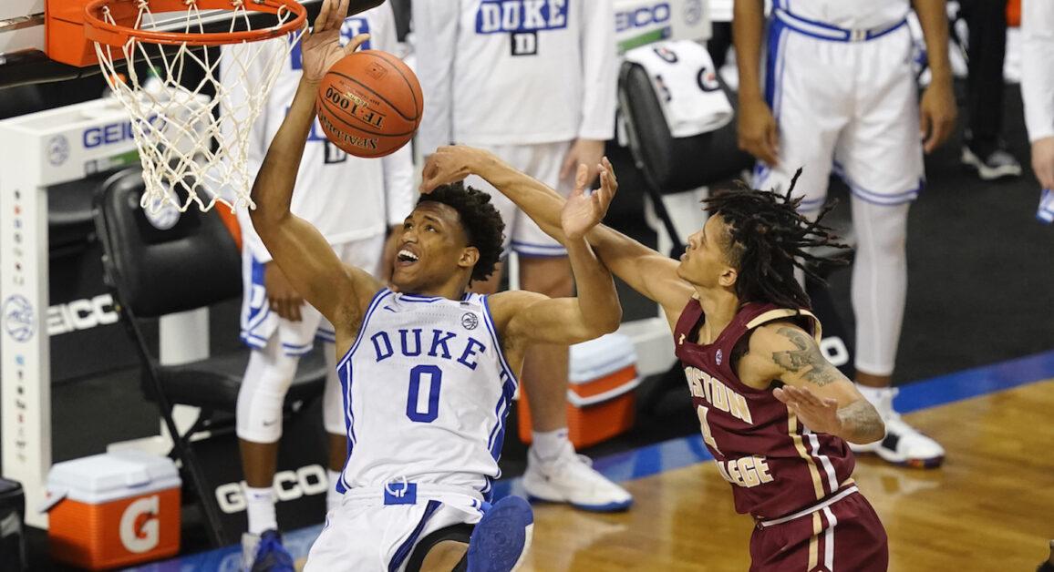 Duke forward Wendell Moore Jr. (0) looses the handle as he drives to the basket as Boston guard Makai Ashton-Langford (4) fouls during the second half of an NCAA college basketball game in the first round of the Atlantic Coast Conference tournament in Greensboro, N.C., Tuesday, March 9, 2021. (AP Photo/Gerry Broome)