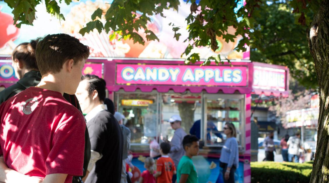 As a carnival ride swung children through the air on the Newton Centre Green Saturday afternoon, customers wove in and out of local businesses. (Victor Stefanescu / Heights Editor)