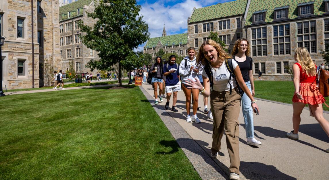 BC student waved for the camera while crossing the Quad on Thursday, September 28, 2023 (Ashton Kao / Heights Staff).