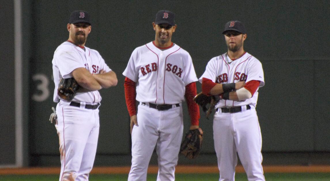 Alex Cora standing in between Kevin Youkilis and Dustin Pedroia. (Eric Kilby / Wikimedia Commons)