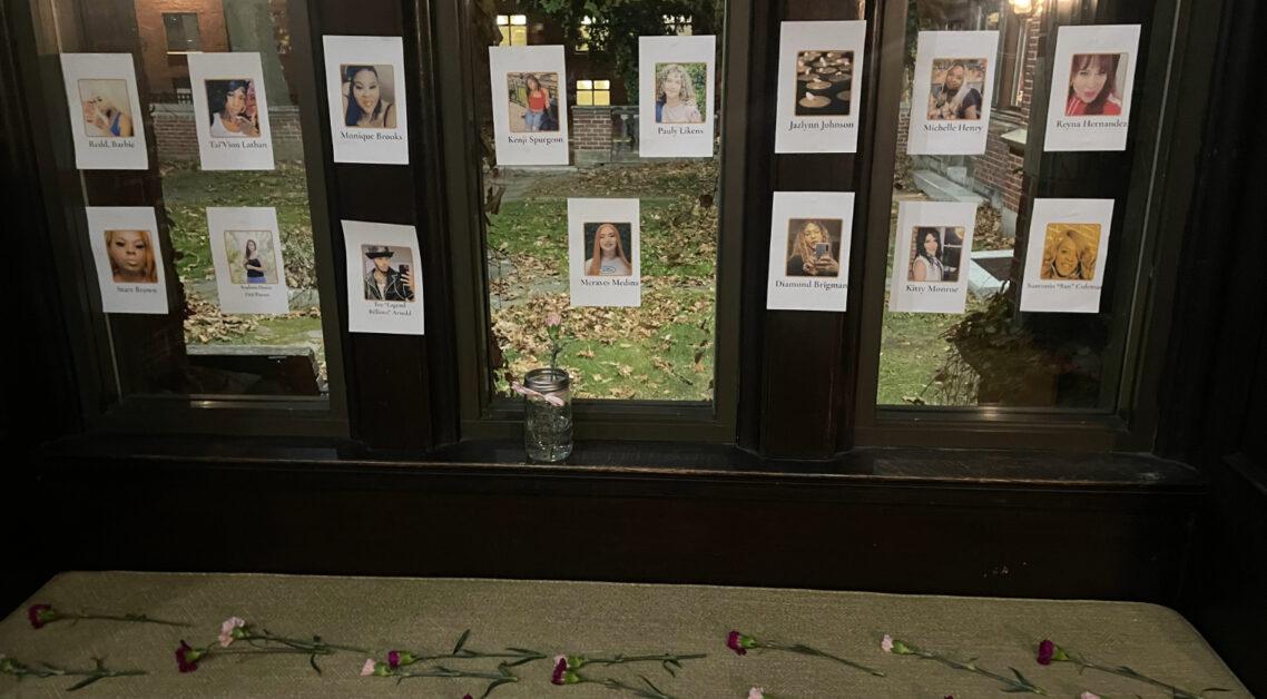 The O'Connell House grew silent as members of the Queer Leadership Council (QLC) read aloud the names of transgender people killed this year in the United States, placing flowers in front of their photos.