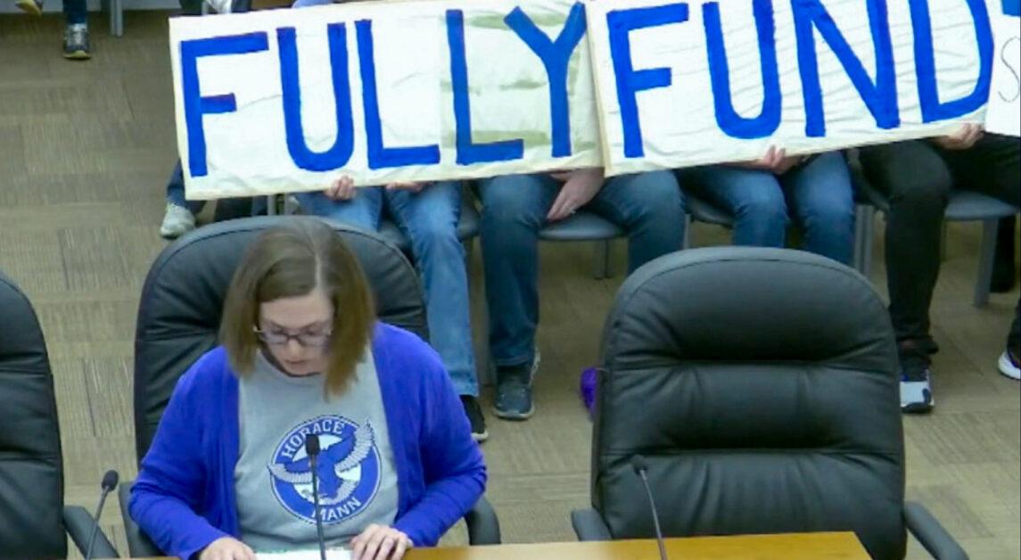  At Monday’s meeting, a row of parents held a large banner demanding that NSC “Fully Fund.” (Matthew Antonecchia / Heights Staff) 