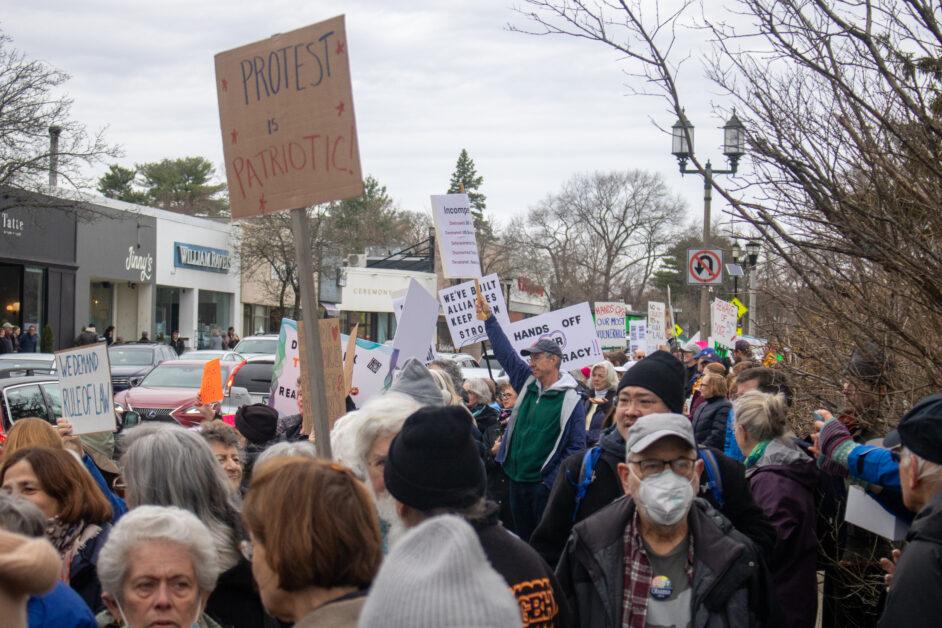 On Saturday afternoon, Newton residents protested in Newton Centre as part of nationwide “Hands Off” demonstrations.
